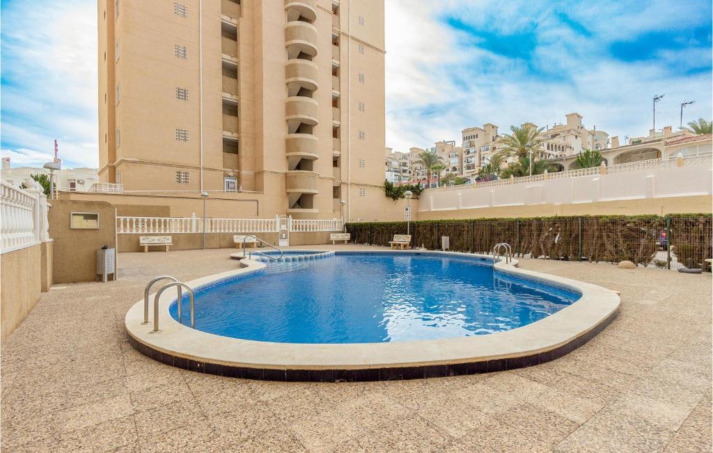 a large swimming pool in the middle of a building at Lovely Apartment In Torrevieja in Torrevieja