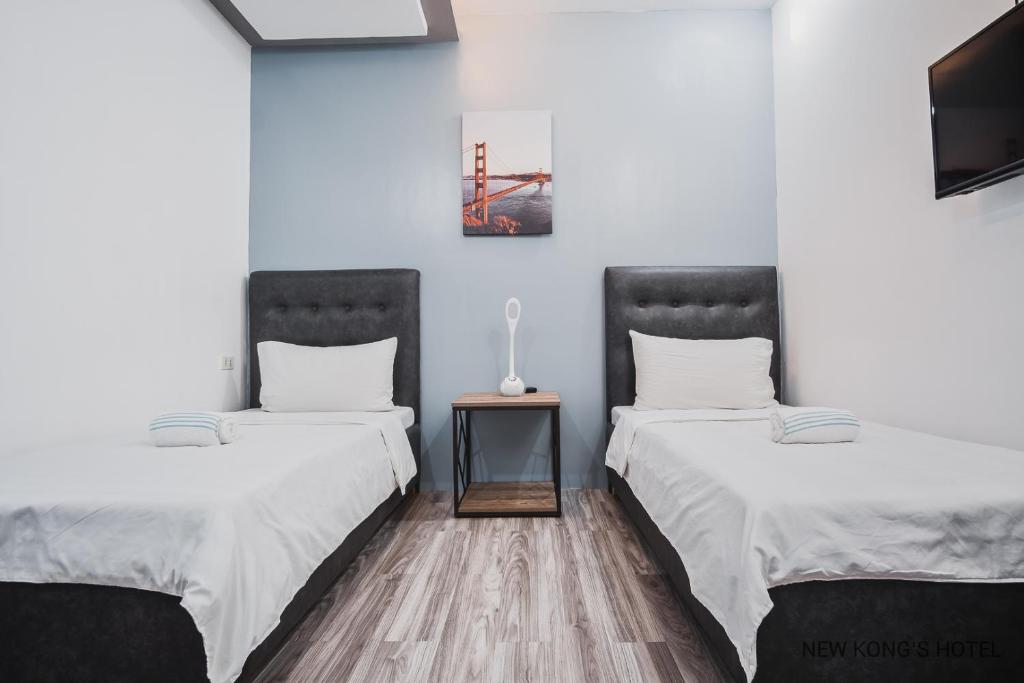 Postel nebo postele na pokoji v ubytování New Kong's Hotel
