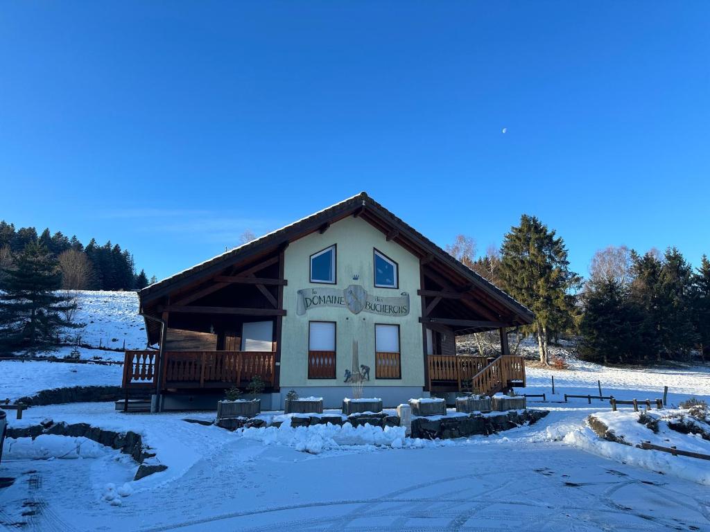 a large building with snow on the ground at Le Bucheron au cœur du massif des Vosges 3 étoiles in Gérardmer