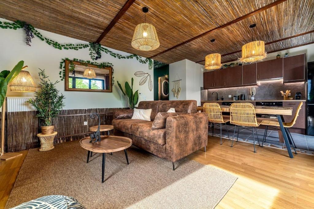 un salon avec un canapé et une cuisine dans l'établissement Le Repaire de Simba - Near DIsneyland Paris, à Montévrain