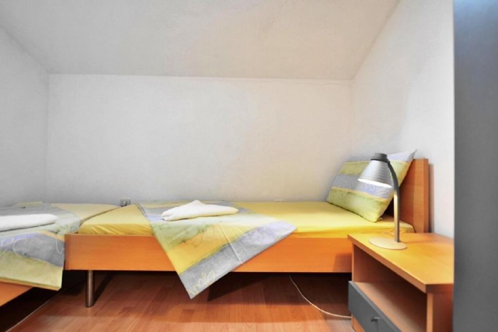 Postel nebo postele na pokoji v ubytování Apartments Nikola