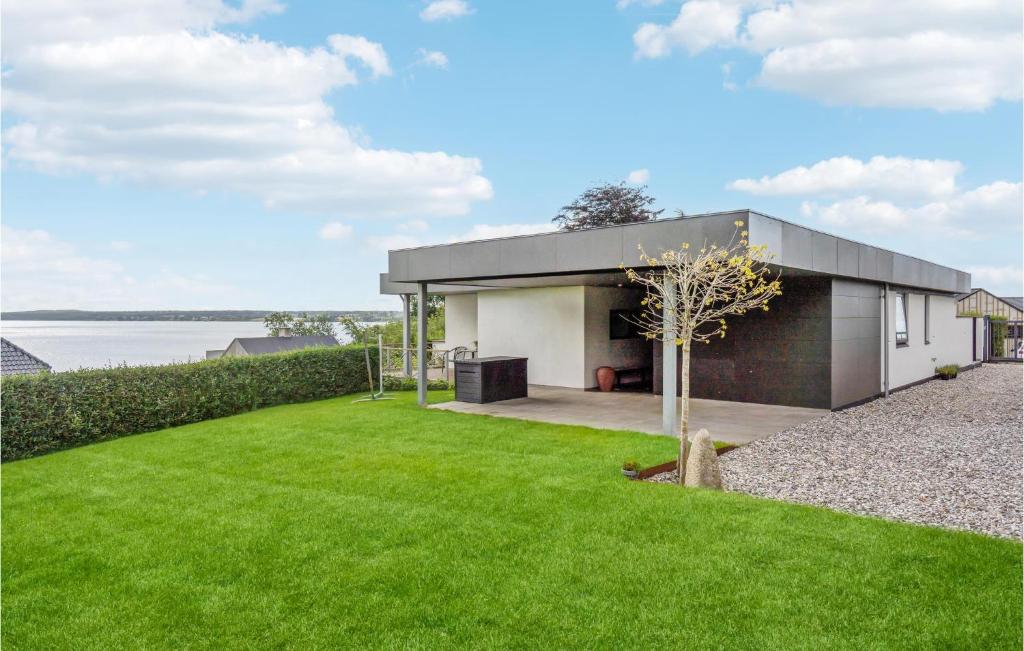a house with a green lawn in front of it at 3 Bedroom Lovely Home In Børkop in Børkop