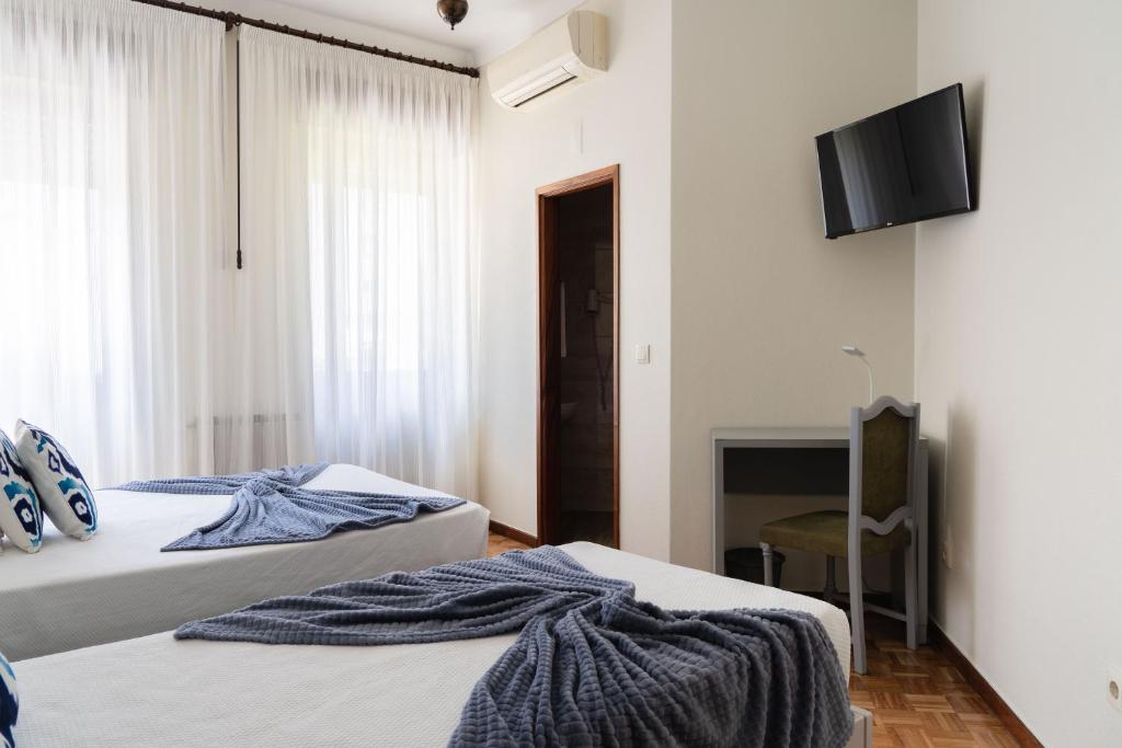 Postel nebo postele na pokoji v ubytování Residencial Clássico