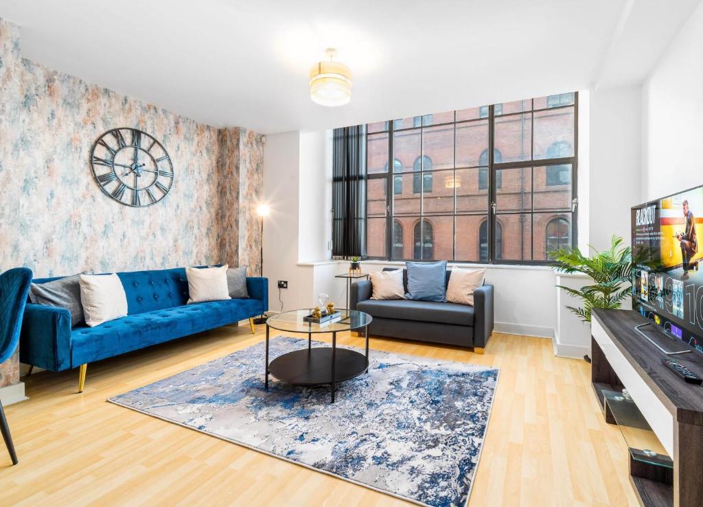 a living room with a couch and a table at LUXURY SEA BLUE-Birmingham central apartment in Birmingham