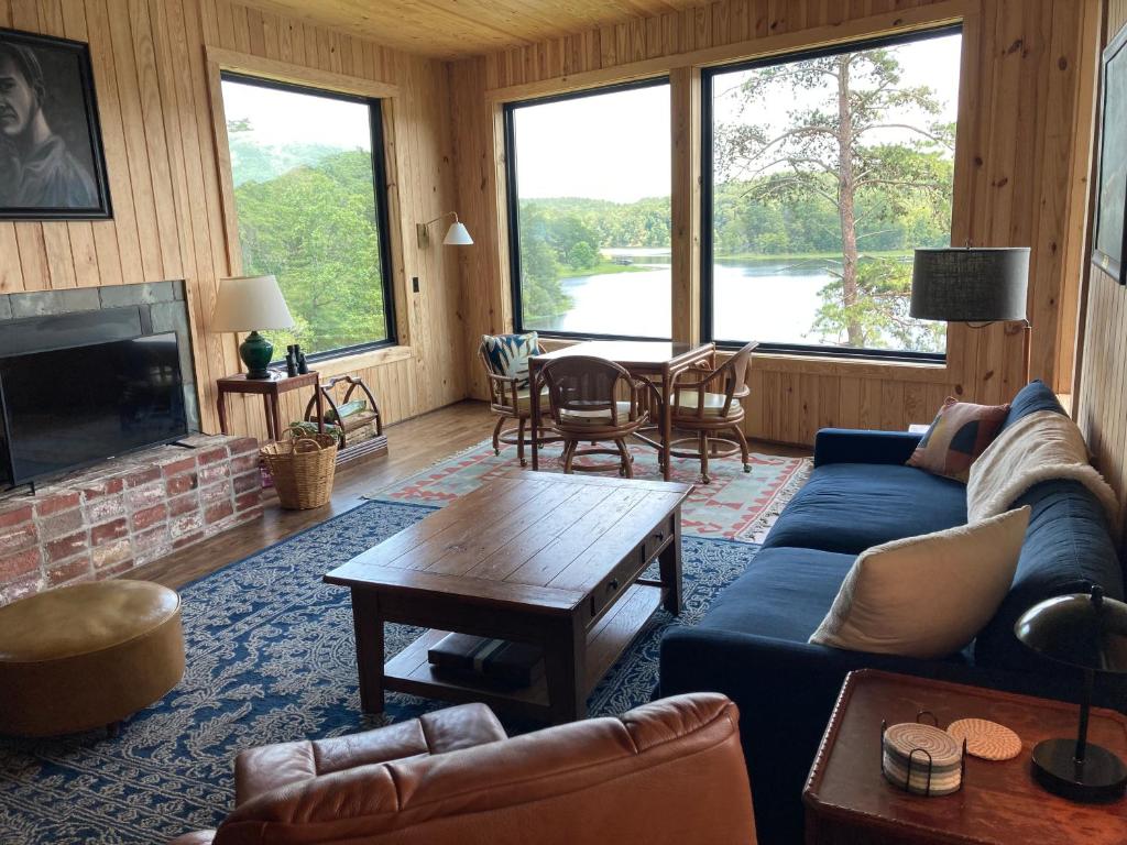 a living room with a couch and a table at Lakefront 3BR Cabin Retreat in Samantha