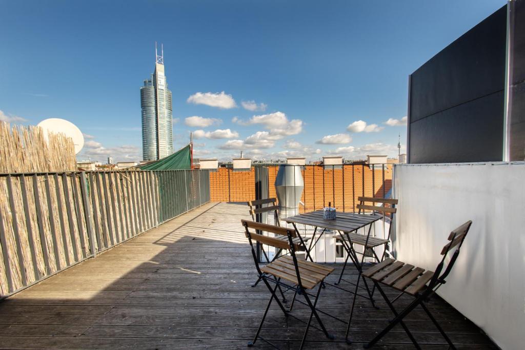a patio with a table and chairs on a balcony at Ley Apartments Vienna in Vienna