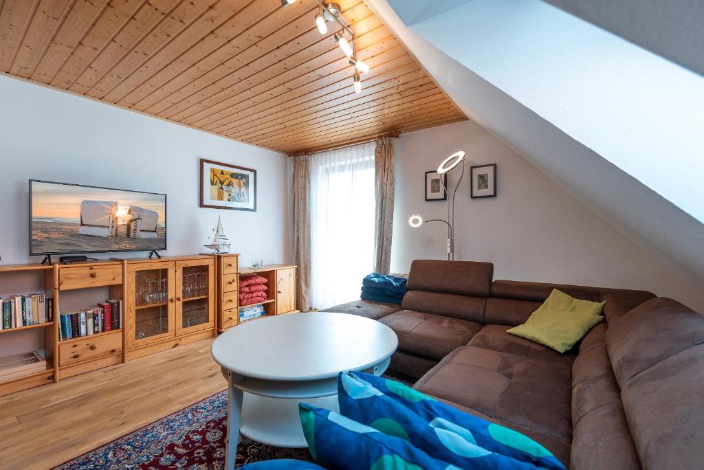 a living room with a couch and a table at Ackerweg, App 01 in Ueckeritz