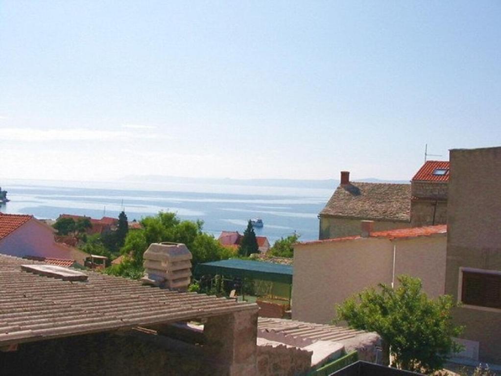 a view of the ocean from the roofs of buildings at Apartments Matej in Bol