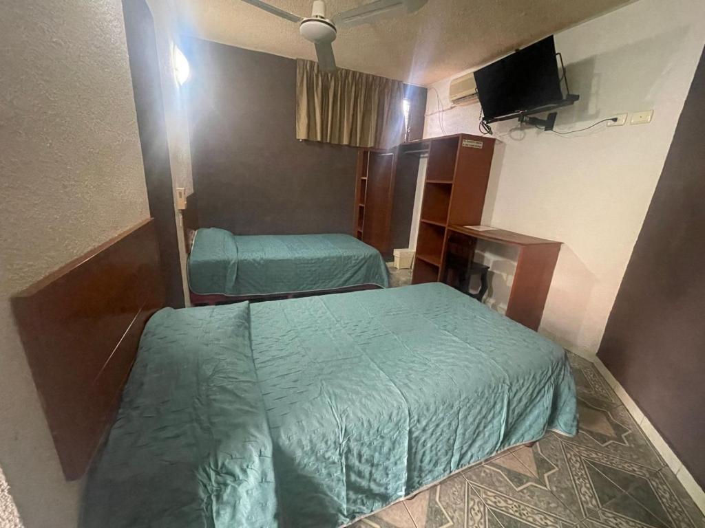 Postel nebo postele na pokoji v ubytování Hotel Lol Tun