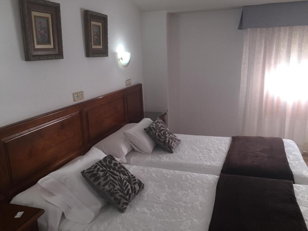 Postel nebo postele na pokoji v ubytování Hotel Martin