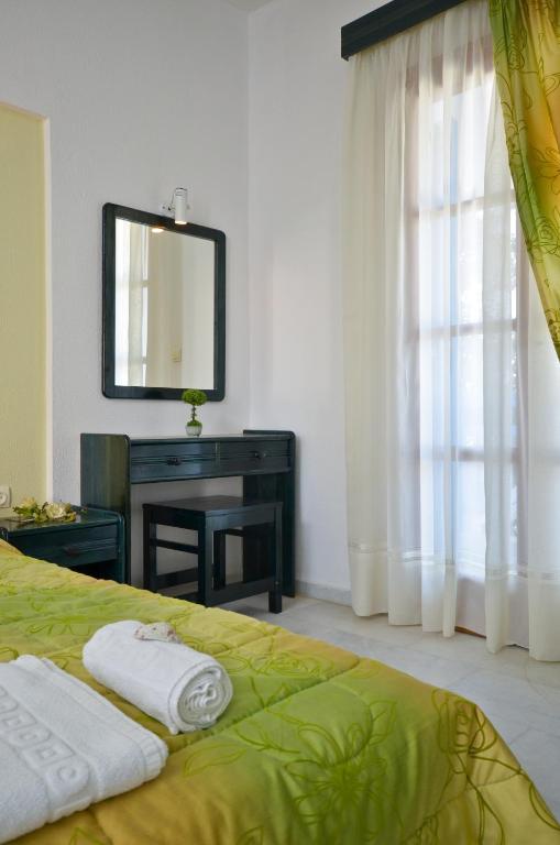 Postel nebo postele na pokoji v ubytování Dilino Hotel Studios