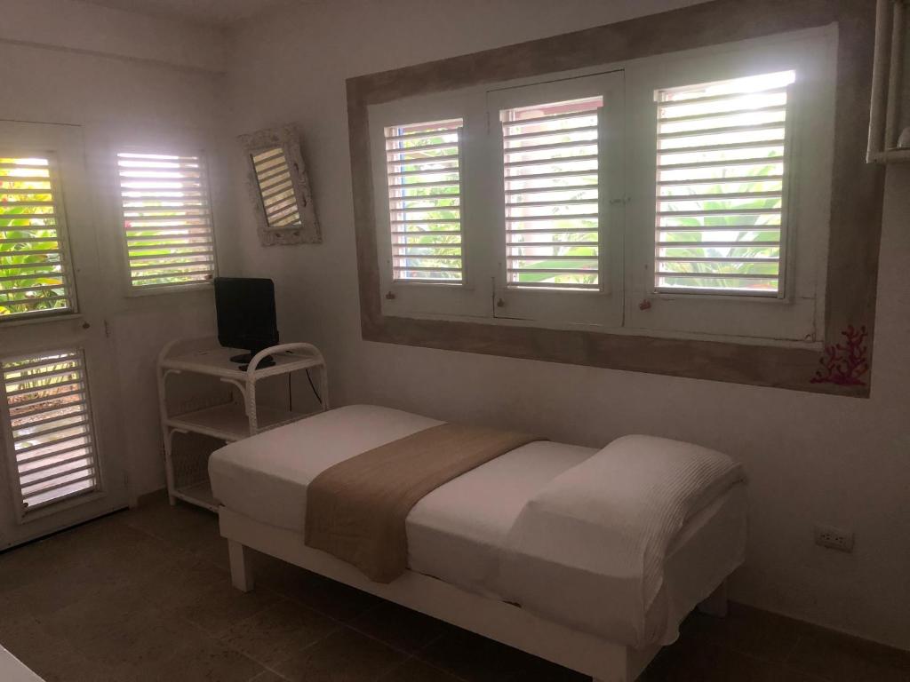 Postel nebo postele na pokoji v ubytování Hotel Casa Robinson