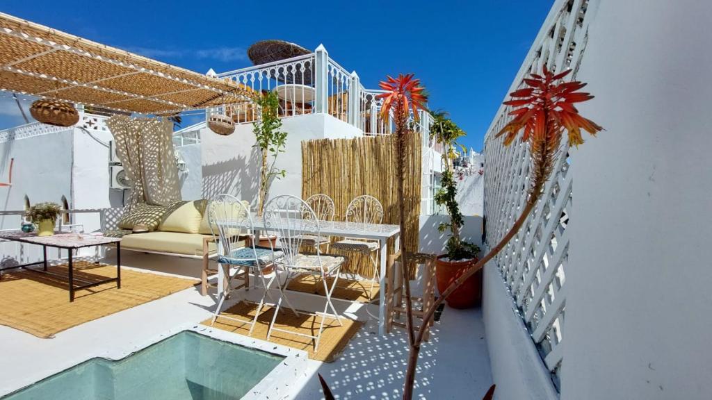 a patio with a table and chairs on a balcony at DAR MOUIMA in Tangier