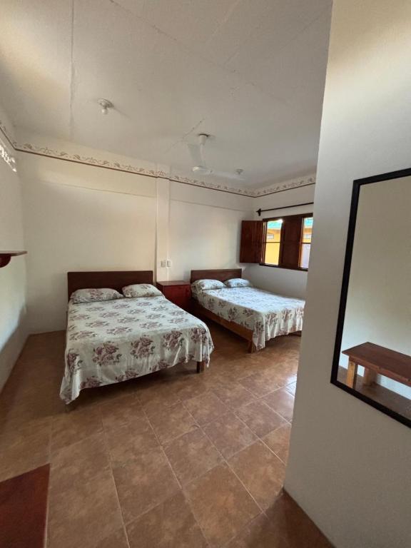 Postel nebo postele na pokoji v ubytování Hotel Posada Playa Manzanillo