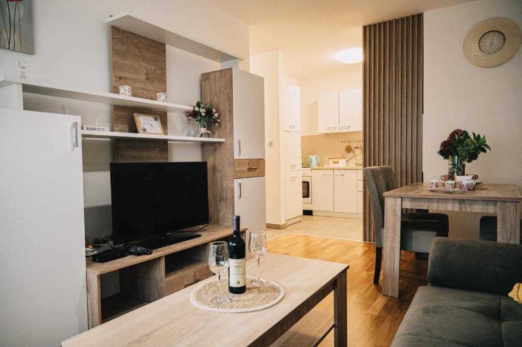 a living room with a couch and a table with a television at Apartman Valerija in Doboj