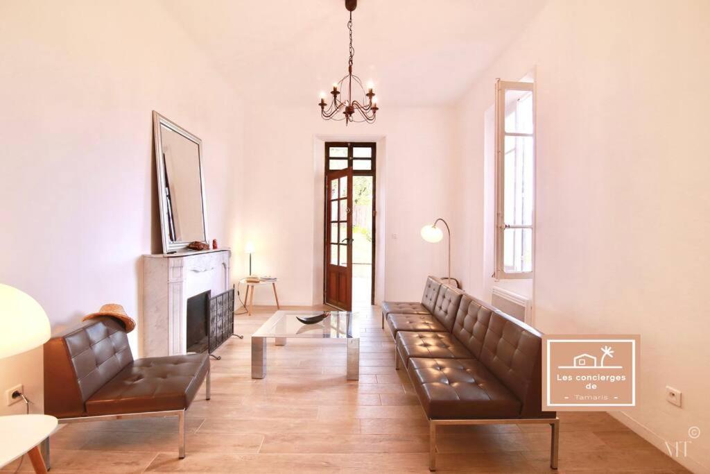 un salon avec des canapés en cuir et une télévision dans l'établissement Villa L'olivier, à La Seyne-sur-Mer