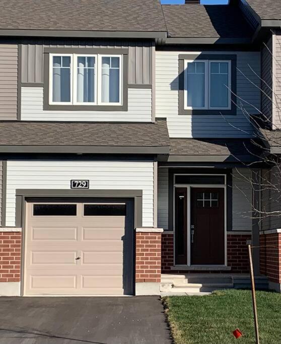 a house with two garage doors at Brand new house in Ottawa