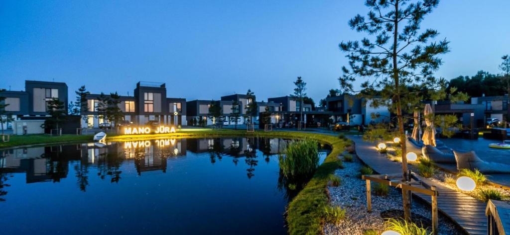 a view of a lake in a city at night at Mano jūra Small rest house in Palanga
