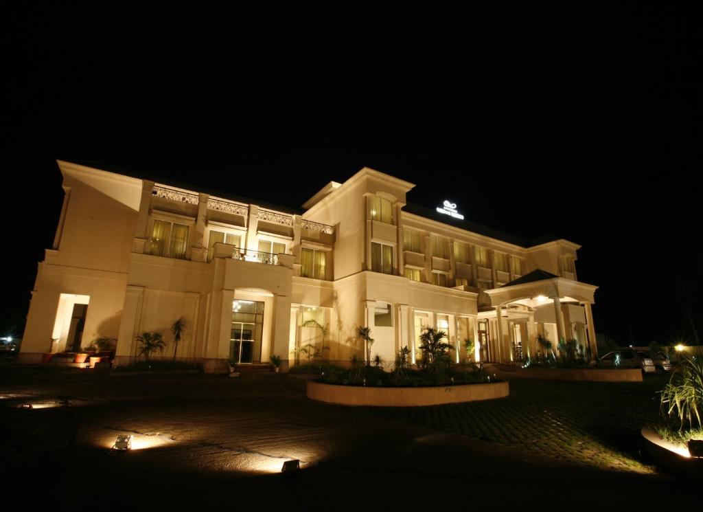a large building at night with its lights on at Ambrosia Sarovar Portico in Haridwār