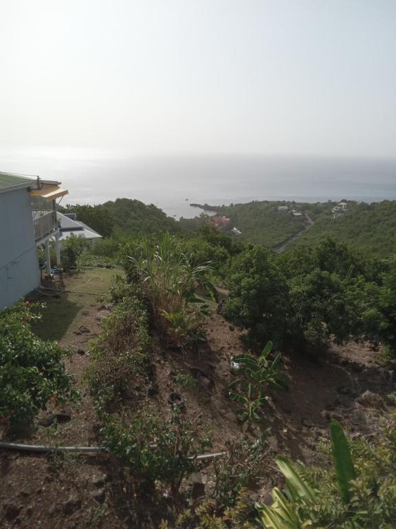 a view of the ocean from a house at La Plus Grande Source D'eaux Chaudes " Guadeloupe " in Bouillante