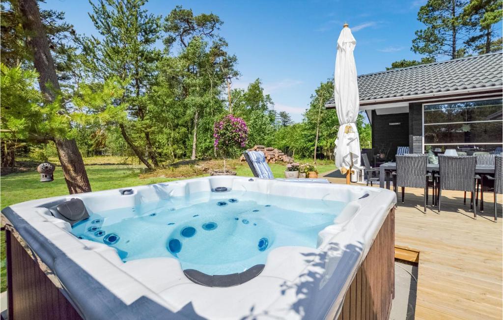 a hot tub in the backyard of a house at Four-Bedroom Holiday Home In Hojby in Højby