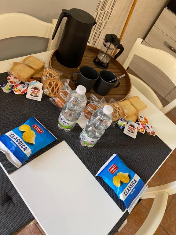 a table with snacks and water bottles on it at Diletta house in Catania