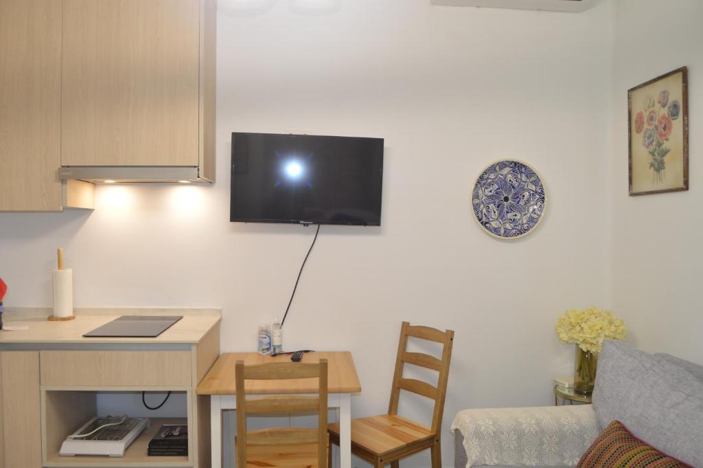 Televízia a/alebo spoločenská miestnosť v ubytovaní FLEMING Loft PARKING Tourist Córdoba