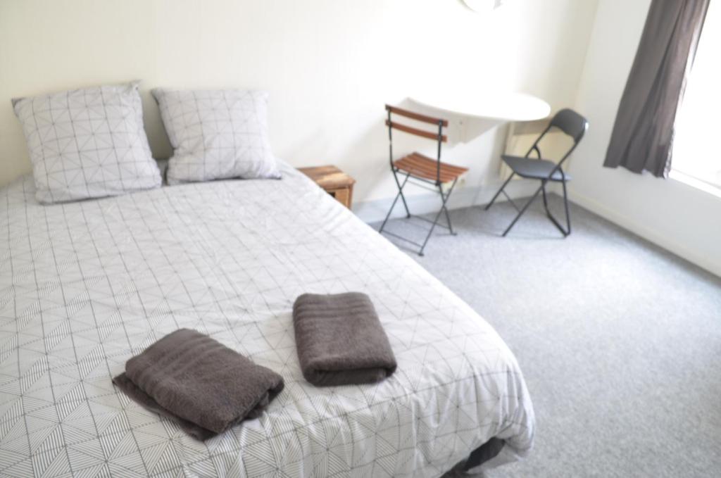 une chambre avec un lit avec deux serviettes dessus dans l'établissement Studio Paris 18, à Paris