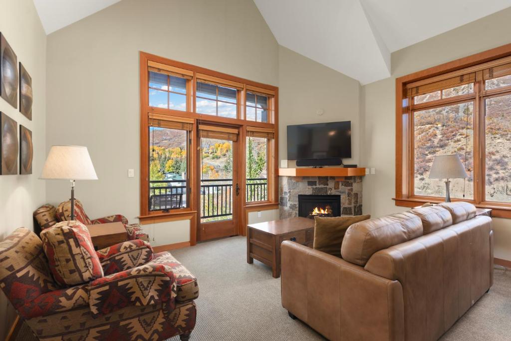 a living room with a couch and a fireplace at Pinecone Perch Capitol Peak Lodge #3227 in Snowmass Village