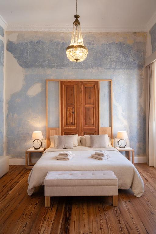 a bedroom with a large bed and a chandelier at Panasco Real Suite - Panasco Suites in Arrecife