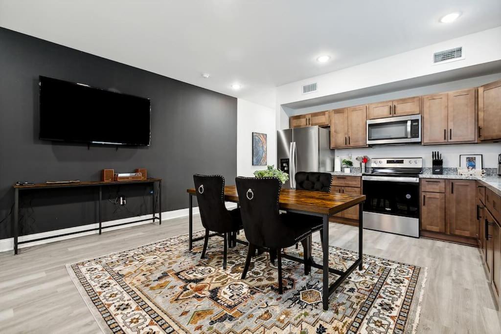 a kitchen with a table and chairs and a tv at 15 Bedrooms in the Heart of NOLA in New Orleans