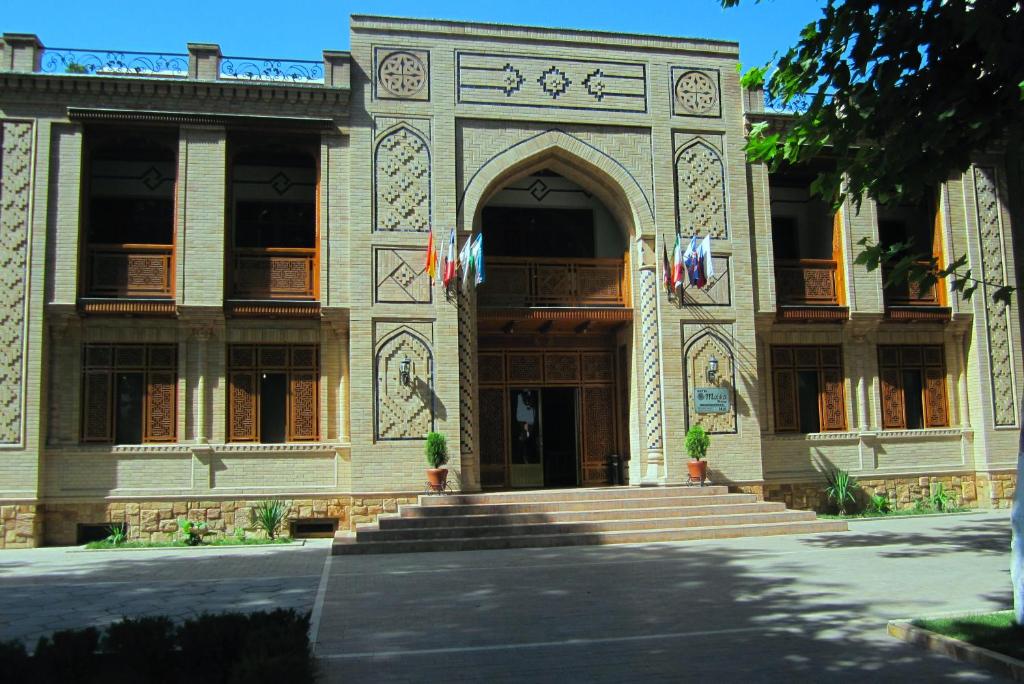 a building with a large door and stairs in front at Malika Prime Hotel in Samarkand