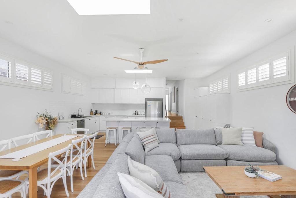 a living room with a couch and a table at Lakeshore Serenity @ Warners Bay in Warners Bay