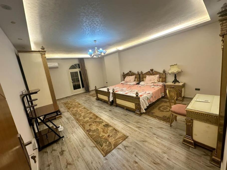 a bedroom with a bed and a dresser in it at King Farouk Palace in Cairo