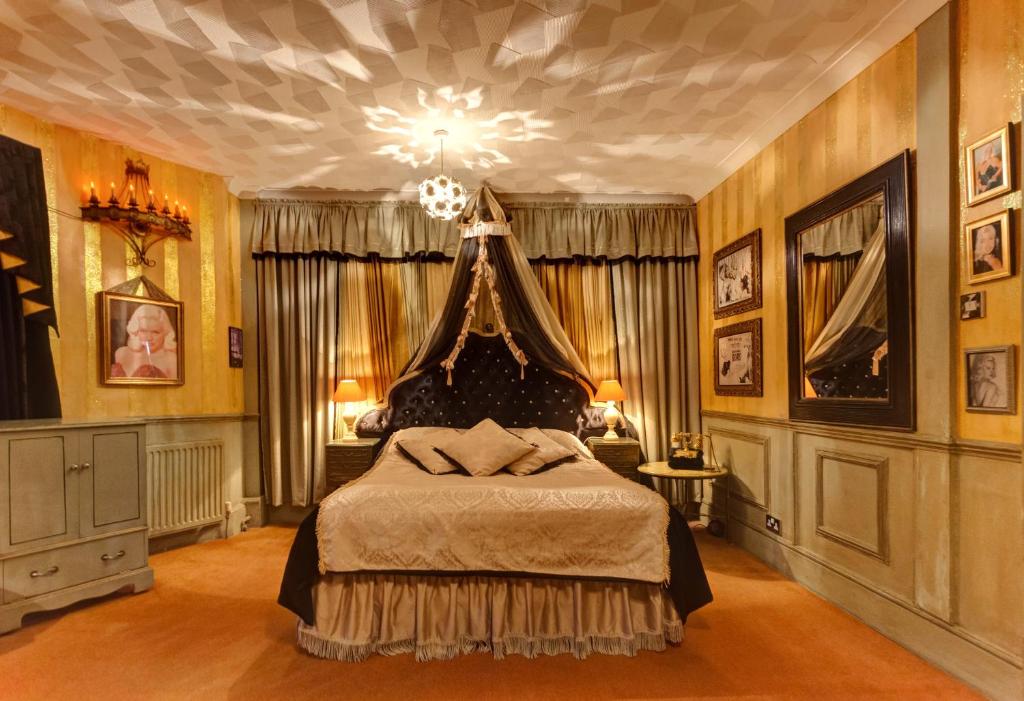 
a bedroom with a large bed and a painting on the wall at Hotel Pelirocco in Brighton & Hove
