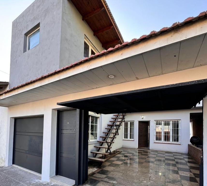 a house with a garage and a stair case at propiedades cerca de Güemes y playa grande in Mar del Plata