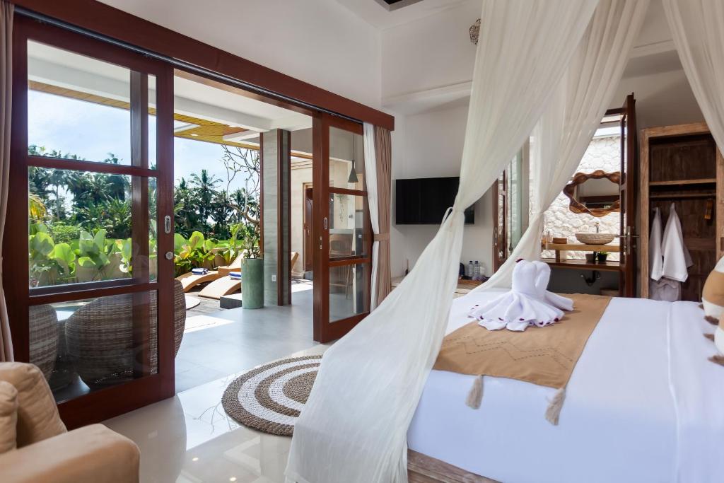 a bedroom with a hammock in a villa at New! The Green Kulu a Romantic 1BDR Private Villa in Tampaksiring