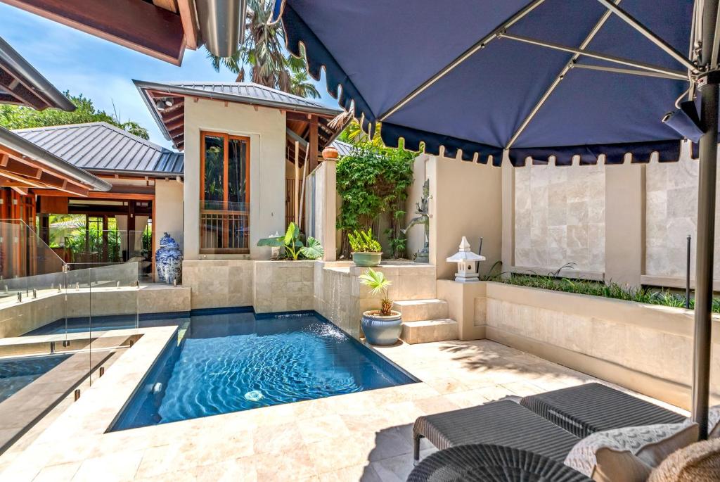 a swimming pool in the backyard of a house at Far Pavilions - An Intimate Bali-style Haven in Port Douglas
