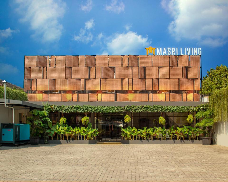 a building with a sign on top of it at Masri Living by Daphna Management in Kejayan