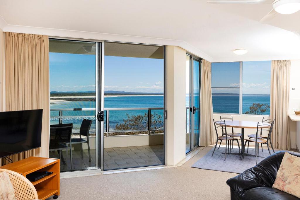 a living room with a view of the ocean at Beachpoint, 401 in Forster