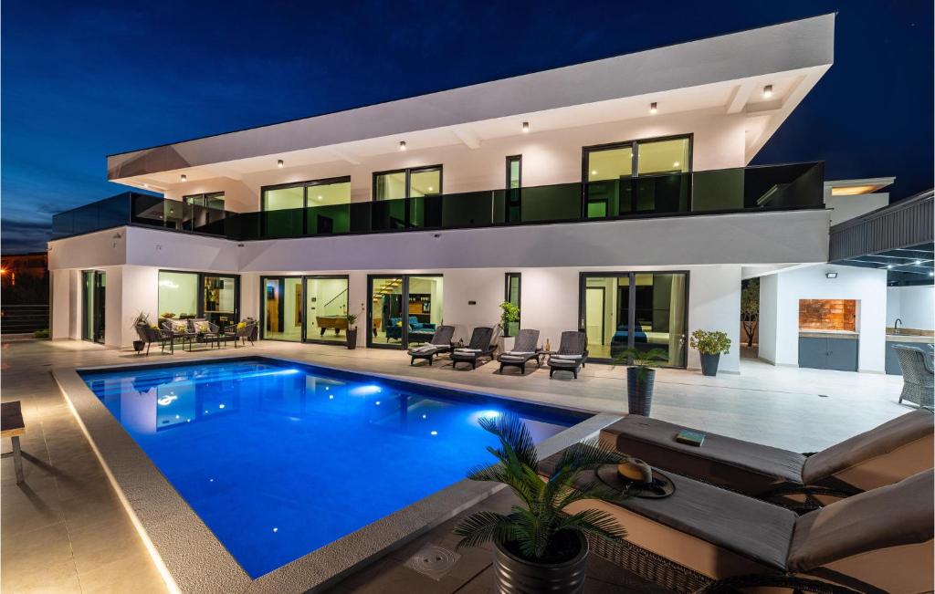 a villa with a swimming pool at night at Villa Hill in Maslenica