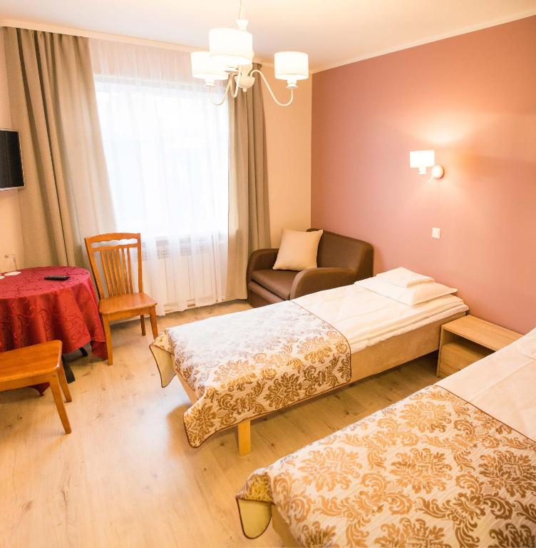 Postel nebo postele na pokoji v ubytování Ankur Hotell