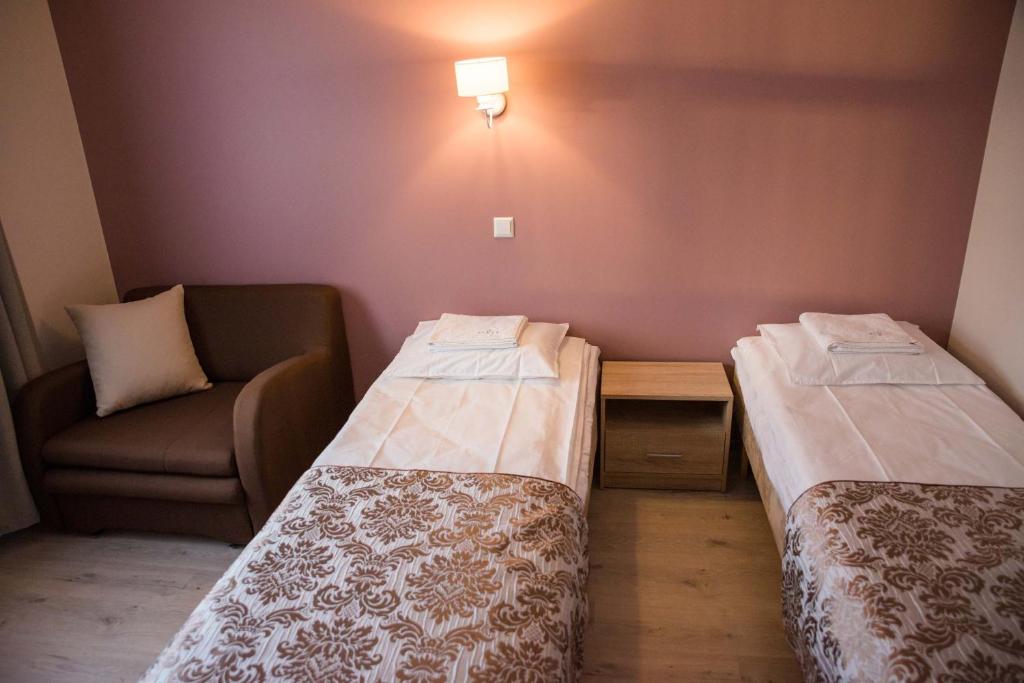 Postel nebo postele na pokoji v ubytování Ankur Hotell