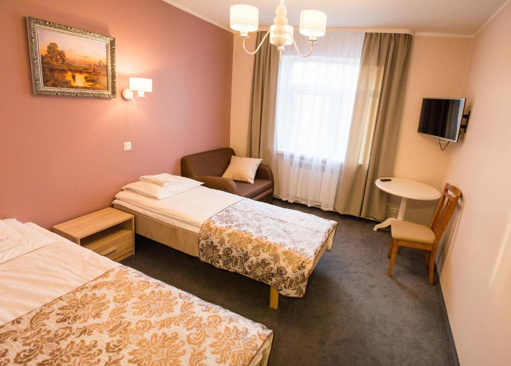 Postel nebo postele na pokoji v ubytování Ankur Hotell