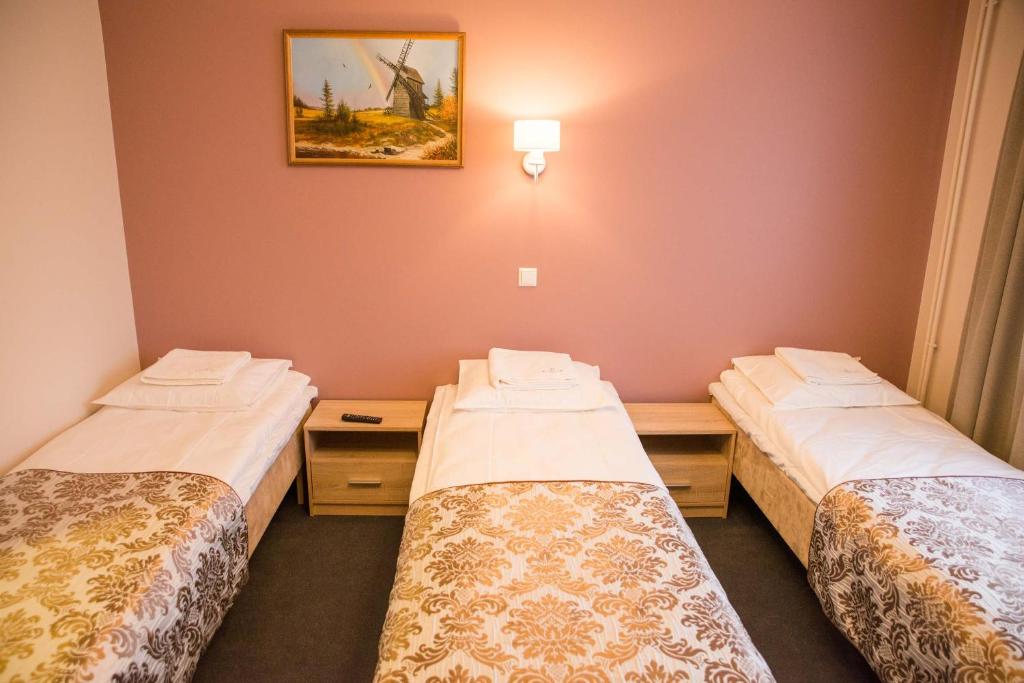Postel nebo postele na pokoji v ubytování Ankur Hotell