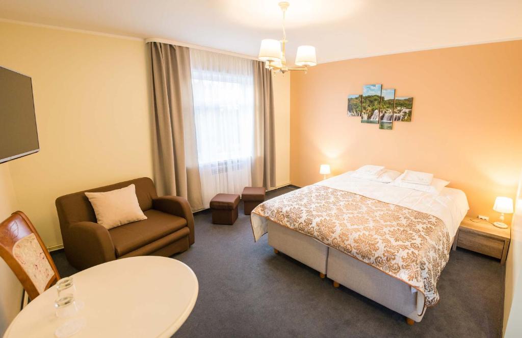 Postel nebo postele na pokoji v ubytování Ankur Hotell