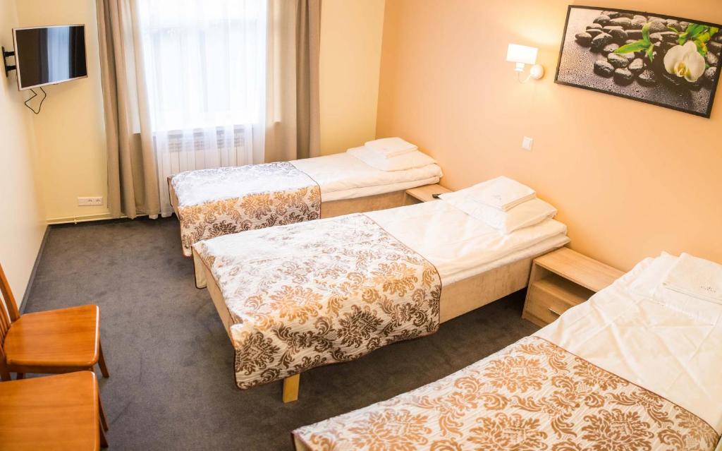 Postel nebo postele na pokoji v ubytování Ankur Hotell