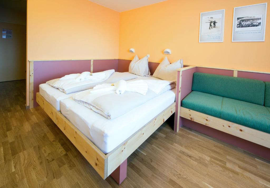 Postel nebo postele na pokoji v ubytování JUFA Hotel Planneralm
