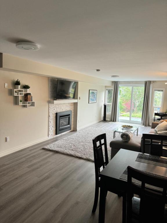 a living room with a couch and a fireplace at Bright private suite near Departure Bay beach in Nanaimo