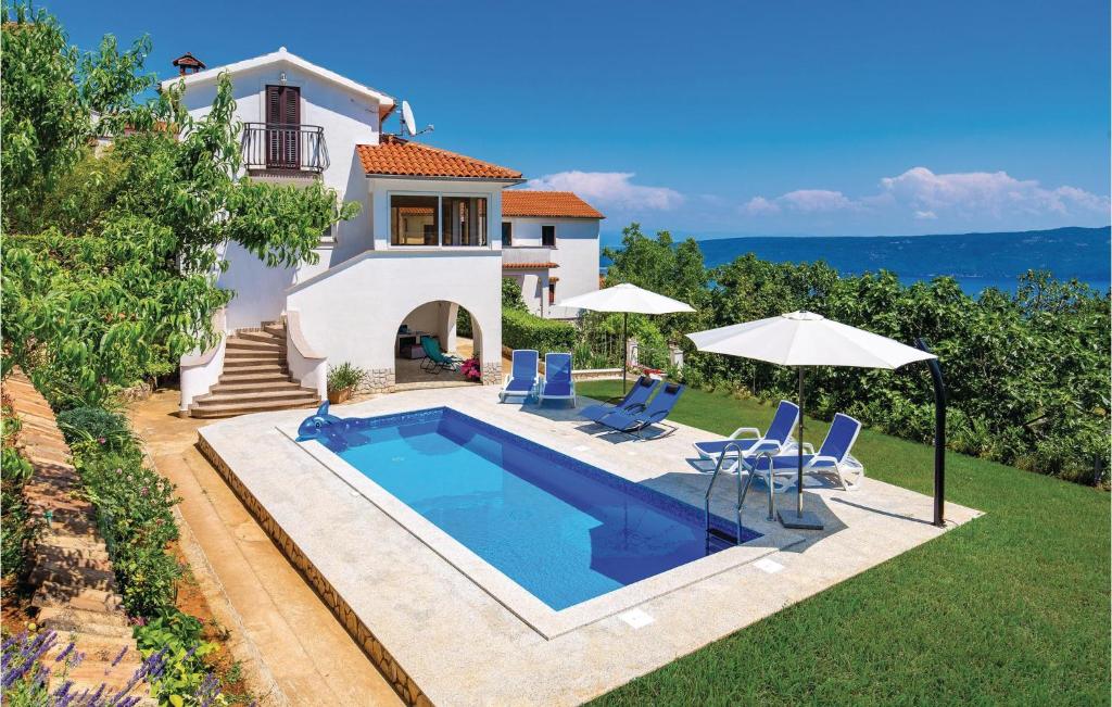 a villa with a swimming pool in front of a house at Nice Home In Brsec With House Sea View in Zagorje